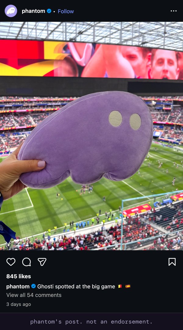 instagram post from phantom's verified account, 845 likes, 54 comments. a purple ghosti plush held up in the stands at the world cup. the caption reads: Ghosti spotted at the big game.